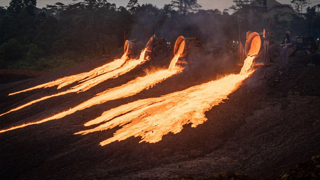 Four trucks dump slag at a nickel-processing plant in Sorowako, South Sulawesi (Image: SOPA Images / Alamy)