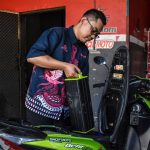 A mechanic in the Indonesian city of Bandung, West Java, replaces the battery of an electric moped (Image: Dimas Rachmatsyah / Alamy)